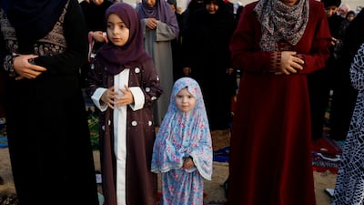 Palestinian girls perform morning prayers to celebrate Eid al-Fitr, marking the end of the holy fasting month of Ramadan, in Khan Younis, in the southern Gaza Strip. Reuters