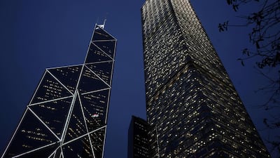 Cheung Kong Centre (R) and the Bank of China Tower at Hong Kong's business Central district. Billions are being spent to bolster local currency. Bobby Yip/Reuters