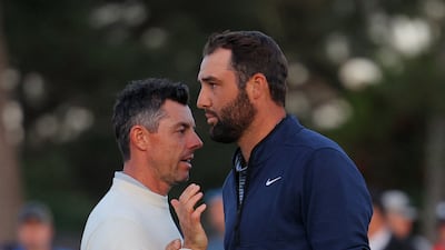 Scottie Scheffler shakes hands with Rory McIlroy after completing their second round. Reuters