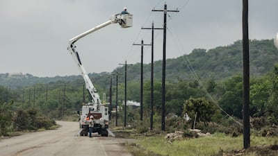 Workers fix electrical lines on a motorway in Texas. AFP