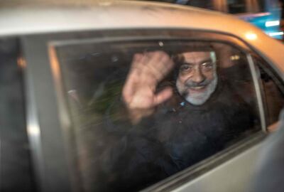 Altan waves in a car as he is detained on November 12, just a week after he was released from prison. AFP