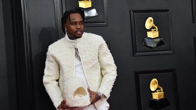 Fivio Foreign, in a pearl jacket with a matching helmet. AFP