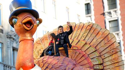 Gia Lopez and Mario Lopez ride the Tom Turkey float. AP