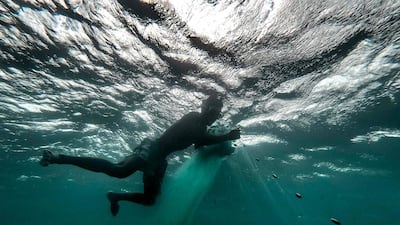 A Malagasy fisherman tends to his net in the waters opposite the fishing community of Anakao, in Madagascar. AFP