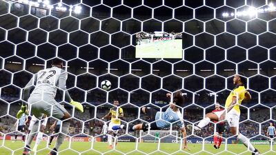 Edinson Cavani of Uruguay scores against Ecuadorian goalkeeper Alexander Dominguez during the Copa America match at Mineirao Stadium in Bello Horizonte, Brazil. EPA