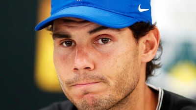A glum Rafael Nadal confirms to reporters on Friday that he is pulling out of the Paris Masters due to injury. Ian Langsdon / EPA