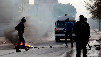 Policemen stand on a street during a demonstration. AFP