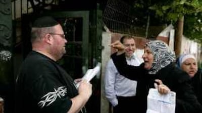 A Palestinian woman argues with a Jewish settler, left, in Sheikh Jarrah.