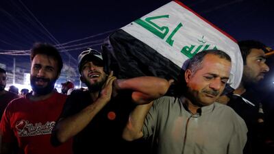 Men carry the coffin of a demonstrator who was killed during anti-government protests, in Baghdad, Iraq. Reuters