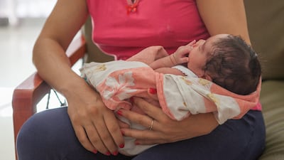 A Tunisian woman holds her son at the Amal shelter for unmarried mothers in Tunis. Sebastian Castelier