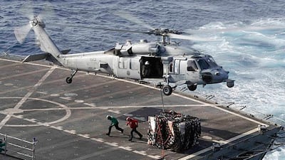 An MH-60S Sea Hawk helicopter transports cargo from the fast combat support ship USNS Arctic to the Nimitz-class aircraft carrier USS Abraham. Mass Communication Specialist 3rd Class Darion Chanelle Triplett/US Navy via AP