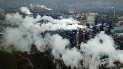 Smoke and steam rise from a coal processing plant in Hejin in central China's Shanxi Province in 2019. The Covid-19 pandemic has proved an unlikely push for green transition amid falling emissions from halted air and ground travel. AP