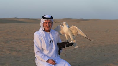 Salem Al Dhabari with one of his prize-winning falcons. His birds have been bought for more than Dh100,000 each. Ravindranath K / The National
