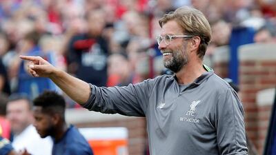 Liverpool manager Juergen Klopp smiles on the touchline. Reuters