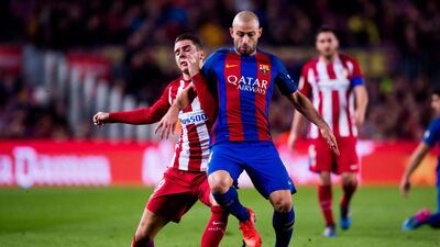 Barcelona's Javier Mascherano fights with Lucas Hernandez of Atletico Madrid for possession. Alex Caparros / Getty Images