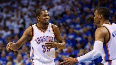 Kevin Durant and Russell Westbrook react during Oklahoma City's Game 4 win over San Antonio on Tuesday night. Ronald Martinez / Getty Images / AFP / May 27, 2014