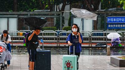 People battle against strong wind as Typhoon Gaemi is set to make landfall, in Taipei, Taiwan. EPA