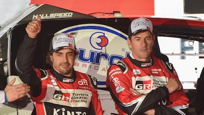 Fernando Alonso (L) gives the thumbs-up with his Spanish co-driver Marc Coma. AFP