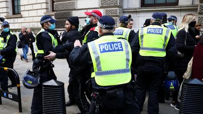 Police officers detain anti-lockdown protestors during a demonstration amid the coronavirus disease (COVID-19) outbreak in London,. Reuters
