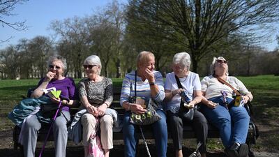 A group of women make the most of the spring sunshine in Regent's Park, London. Under an easing of Covid-19 restrictions, groups of six people can now meet outside in England. EPA