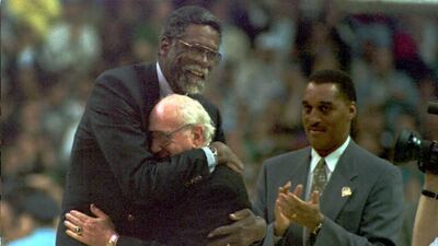 In this 1995 file photo, former Boston Celtic great Bill Russell (L) embraces his old coach and Celtic President Red Auerbach during half time activities commemorating the last regular season game of the Celtics at the Boston Garden. AFP