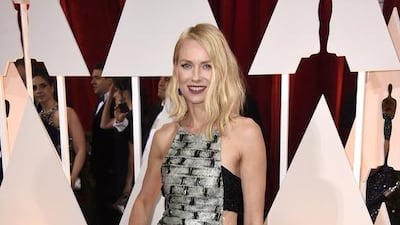 Presenter, Naomi Watts, paired an exquisite black and white, cut-out beaded Armani gown with lapis blue earrings and mulberry purple lipstick. Frazer Harrison / Getty Images / AFP