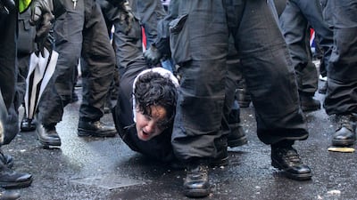 Police officers detain a protester during the Tommy Robinson-led Unite The Kingdom march and rally in central London. A March Against Fascism, organised by Stand Up To Racism, was also staged in the capital. PA