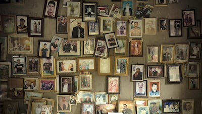 Pictures of Yazidis killed in 2014 by ISIS militants are displayed at a shrine in northern Iraq. AP