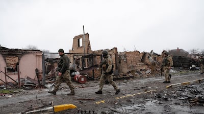 Ukrainian soldiers inspect destroyed Russian military machinery in the areas recaptured by the Ukrainian army in the city of Bucha on April 3, 2022. EPA