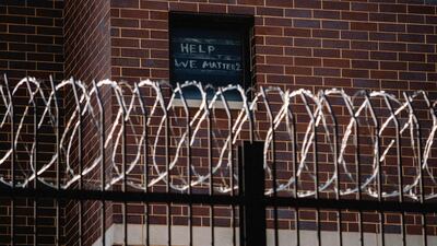 Signs made by prisoners pleading for help are seen on a window of Cook County Jail in Chicago, Illinois, US. Reuters