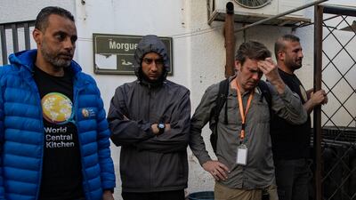 World Central Kitchen workers gather around the bodies of their colleagues after they were transferred to Al Najjar Hospital in Rafah, southern Gaza. EPA