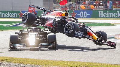 Max Verstappen of Red Bull Racing collides with Mercedes' Lewis Hamilton, left, during the Italian Grand Prix in Monza on Sunday, September 12, 2021. EPA
