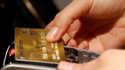 A customer pays with a contactless credit card. Reuters