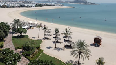 The beach near the building.