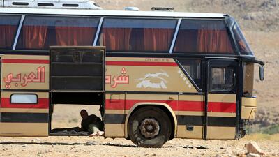 A bus driver rests in Jurud Arsal, Syria-Lebanon border, on August 1, 2017. Ali Hashisho / Reuters
