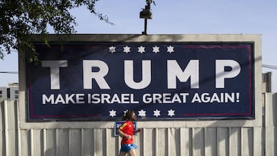 An Israeli jogger passes a pro-Trump placard in Tel Aviv on November 12, 2016. Jim Hollander/EPA