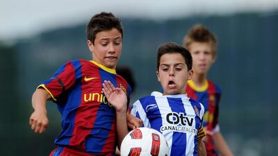 In this file photo, a Barcelona youth player fights for the ball with an Espanyol youth player on one of the pitches at the Joan Camper training ground on May 15, 2011 in Barcelona, Spain. Jasper Juinen / Getty Images
