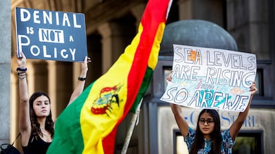 Protesters hold up placards during a climate change protest in New York on Friday. Bloomberg