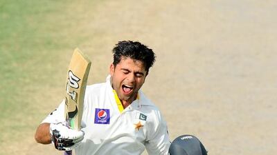 Pakistani batsman Ahmed Shehzad celebrates his century on Saturday during third day of the third Test between Pakistan and Sri Lanka in Sharjah. Ishara S. Kodikara / AFP