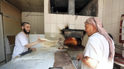 Zanudin makes bread at Shalqar Bakery. Pawan Singh / The National
