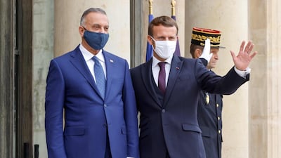 Prime Minister of Iraq Mustafa al-Kadhimi is welcomed by France's President Emmanuel Macron ahead of a working lunch at the Elysee Palace in Paris. AFP