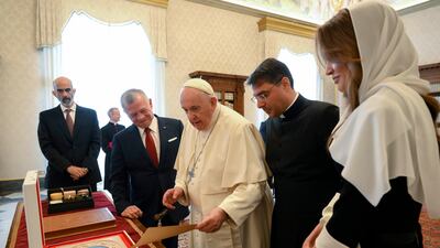 Pope Francis exchanging gifts with King Abdullah and Queen Rania. EPA