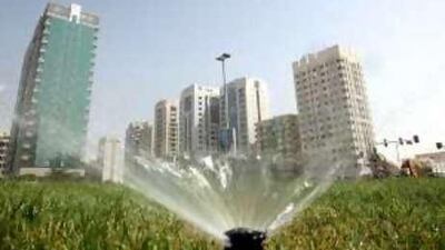 A sprinkler works during the day in Abu Dhabi.