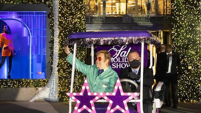Sir Elton John makes his entry at Saks on a golf cart featuring his signature star glasses. Photo: Michael Blanchard
