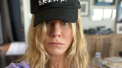 Jennifer Aniston, who played Rachel in 'Friends', wears a 'I know' hoodie and 'We were so not on a break' hat from the limited edition Cast Collection of merchandise