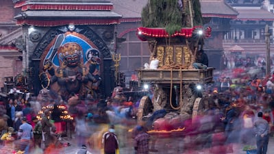 Nepalese devotees offer prayers to a giant chariot of Seto Machindranath, the god of protection, at Hanuman Dhoka Durbar Square in Kathmandu, Nepal. EPA
