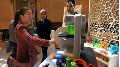 A woman inspects a 3D printer, the likes of which may one day see us printing food and other products at home. Wang Fang / Xinhua Press / Corbis