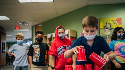 Children wear masks while at school in Houston, Texas. AFP