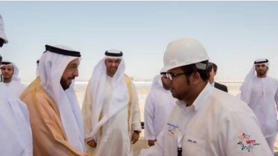 Sheikh Khalifa bin Zayed Al Nahyan President of the UAE and Ruler of Abu Dhabi (L), greets Shams Power Company employees during the Shams 1 opening ceremony. Ryan Carter / Crown Prince Court - Abu Dhabi