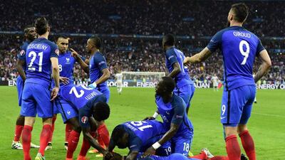 Antoine Griezmann is congratulated by teammates after scoring France’s fourth goal. Tobias Schwarz / AFP